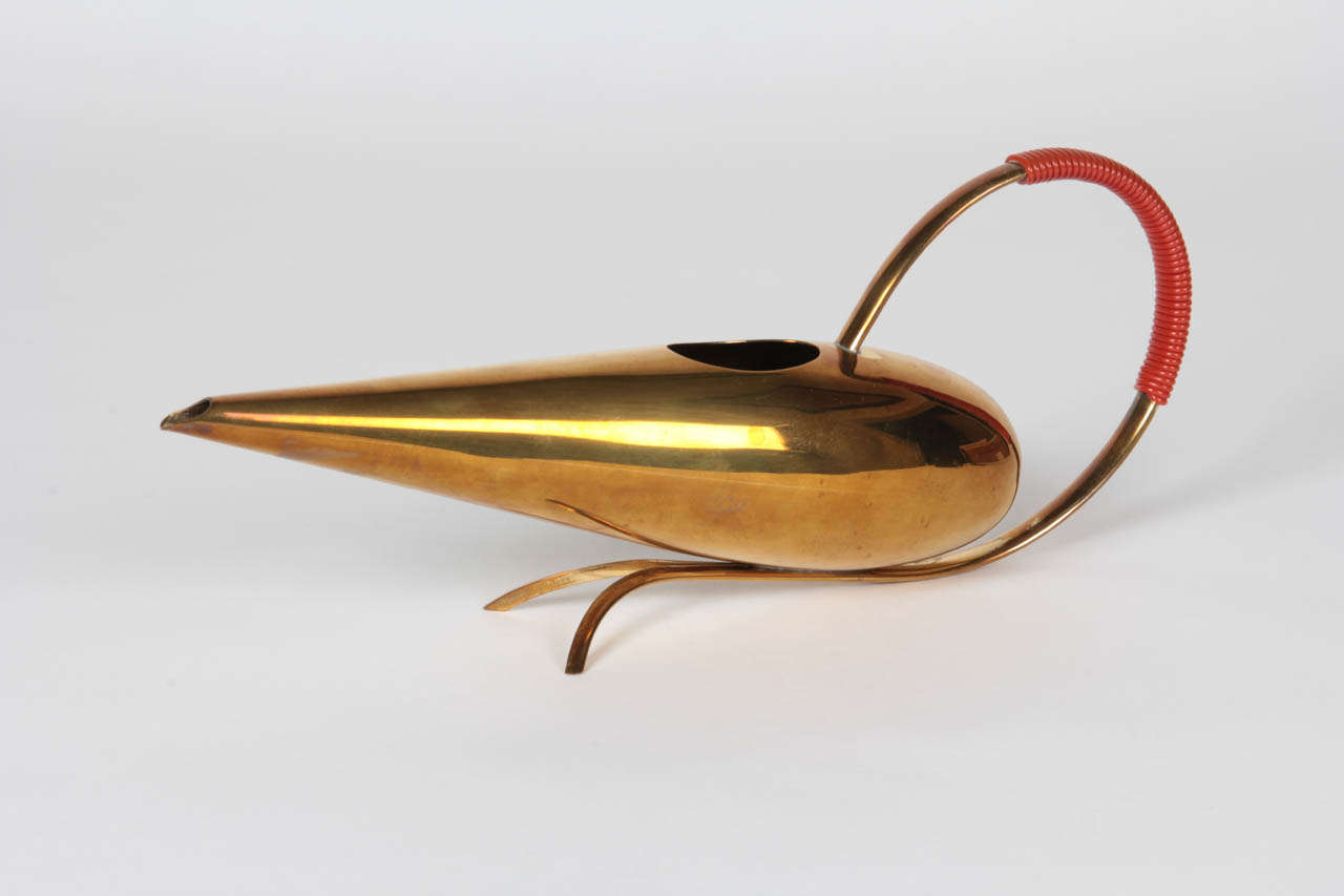 WMF  [Württembergische Metallwarenfabrik]  Geislingen, Germany
Günter Kupetz (b.1925) Germany

Water Pitcher  circa 1954

Brass in a teardrop shape with an arching handle wrapped with a woven coral cording.

Marks: WMF (in a square)

For