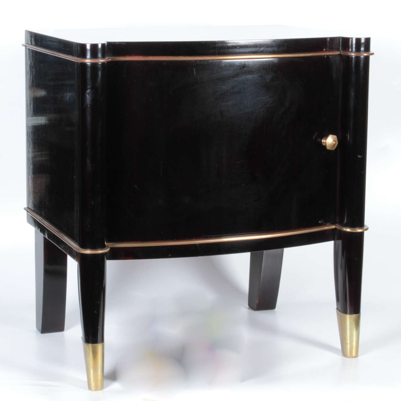 Pair of antique French Art Deco black lacquer and gilt bronze side cabinets or tables. There is gilt bronze feet, knobs and trim around the cabinets. The inside of the side cabinets are finished, circa 1930.