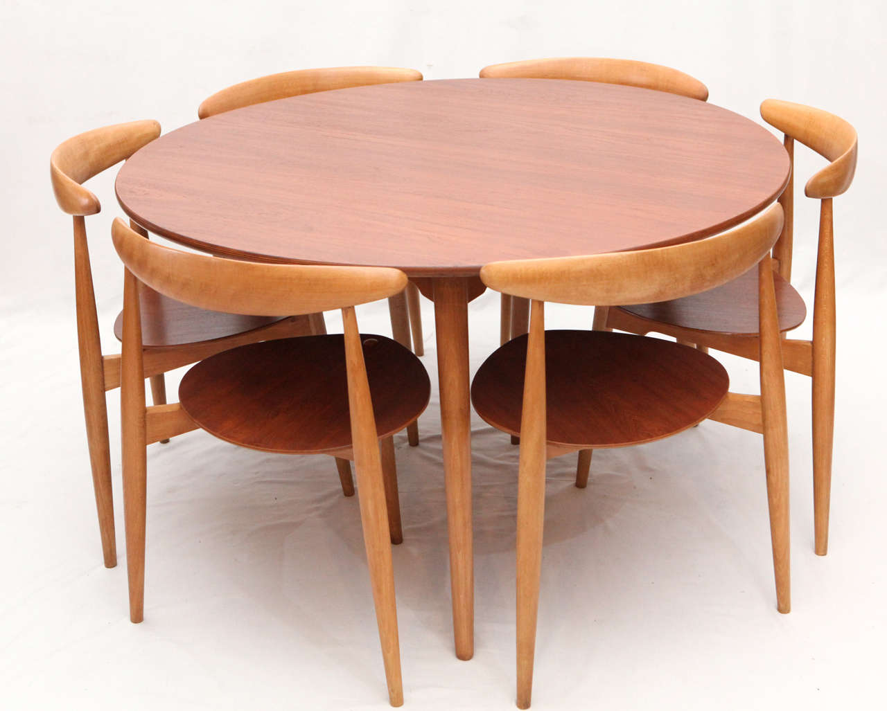 Hans Wegner three leg table with matching three leg chairs designed in 1953 and produced by Fritz Hansen.