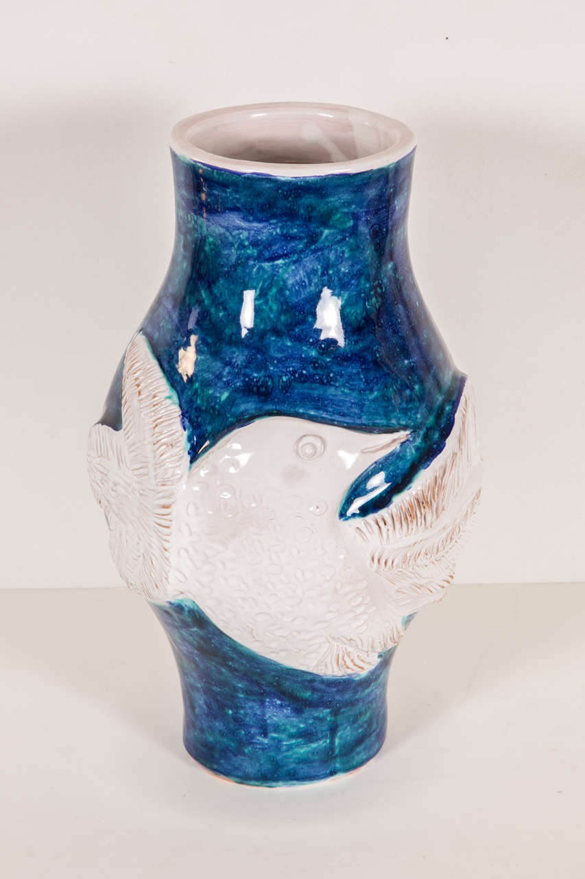 Large blue vase with white relief bird called 