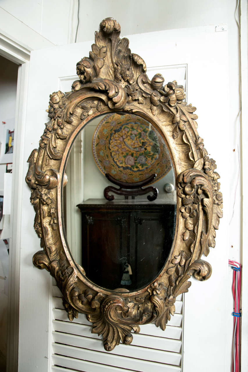 Pair of Oval Rococo Style Giltwood Mirrors