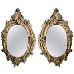Pair of Oval Rococo Style Giltwood Mirrors