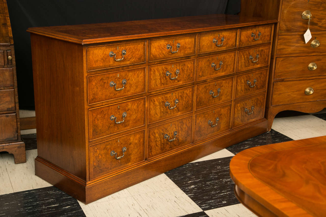 Made for us by our English cabinetmaker with an eye toward serving double duty as an office credenza, or a dining room server, this walnut burl server appears to have 16 drawers. However, with a nod toward functionality, only the first eight drawers