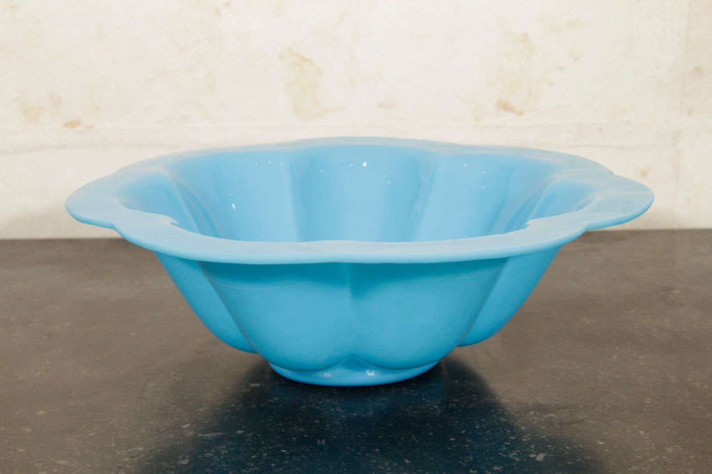 This Chinese glass bowl has an opaline turquoise blue scalloped body and rim. The base of the bowl is etched 
