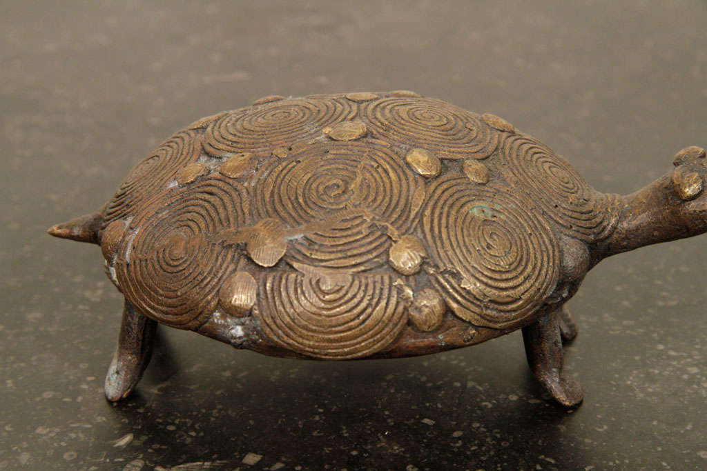 This African brass turtle was made by Akan tribe as a gold counter weight for trading purposes.