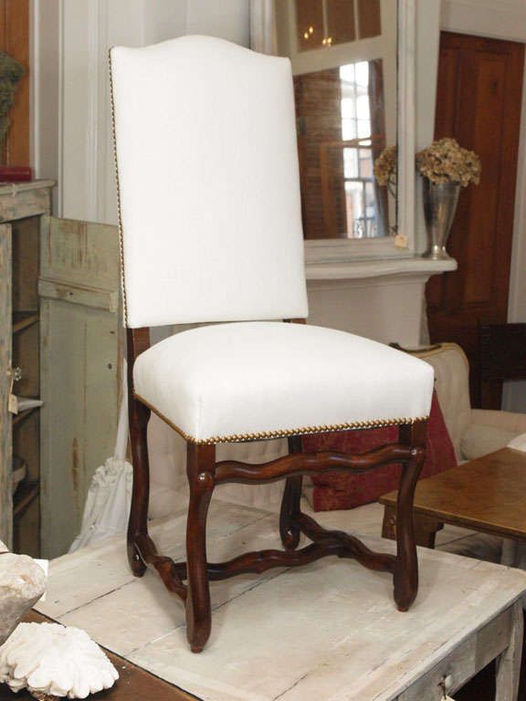 Beautiful set of 8 French Louis XIII style dining chairs.  Completely restored down to the springs.  Newly upholstered in Belgium linen (or COM, if you prefer)* with french brass nailhead trimming around the back and seat. Pair of armchairs to match
