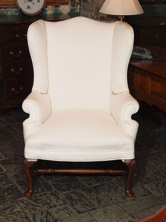 Antique English mahogany Georgian style wingback chair with stretcher base.