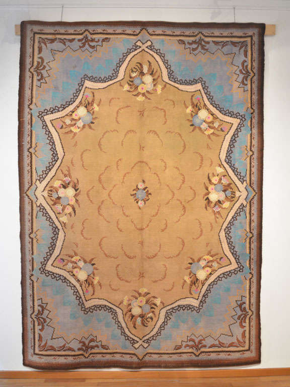 Early Art Nouveau carpets display a decoration that is reminiscent of the late nineteenth century 'Second Empire' weavings of the Napoleon III period, yet with touches of innovation in certain details of the pattern. This Art Nouveau rug shows a