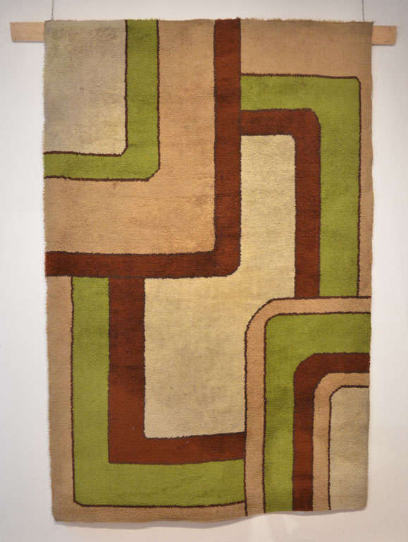 Les tapis Rya tissés à la machine étaient très populaires en Europe au milieu du XXe siècle, car ils constituaient une alternative abordable aux tapis noués à la main et étaient souvent décorés, comme dans ce cas, de motifs modernistes.
Une pièce