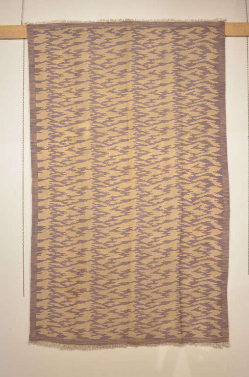 An unusual wool flat-weave distinguished by an all-over pattern similar to a stylized tiger pelt in purple on an ivory background. This kilim was collected in Turkey a few years ago and it had been reputedly commissioned for a hotel in Istanbul