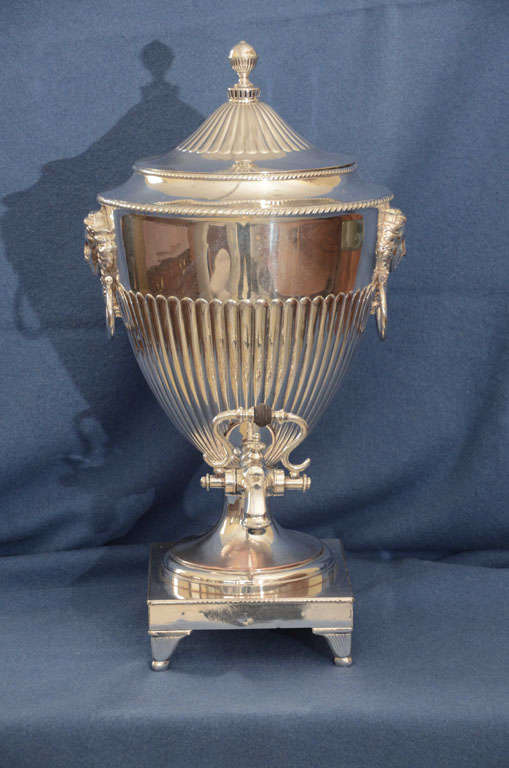 Large Silver Plated Hot Water Urn With Greek Diety Medallions -- Graduated Fluting To Sides And Lid With Ball Finial-- Oval Ring Handles--Spigot With Swan Neck Lever Centered With Ebony Ball