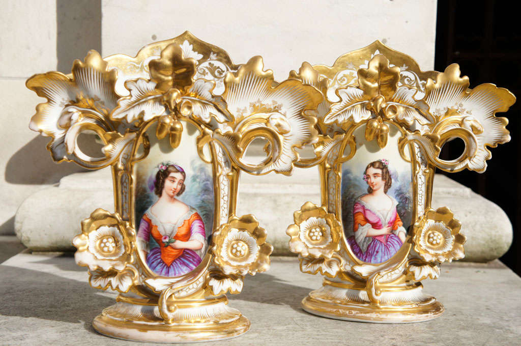 This large and impressive pair of vases are excellent examples of the work done in France for the American Market. In and around Paris factories took blanks and gilded and painted vases and plates creating custom work for sale to home grown