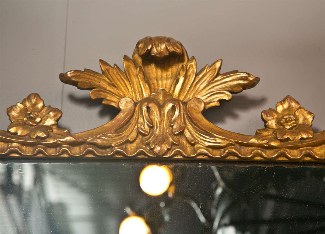 Hand carved and guilded french style mirror, monumental size with great carving. Sure to be a focal point in any room.