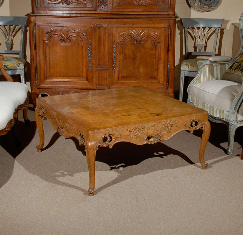 Square French style oak coffee table with parquetry top, pierced apron with central urn carving on  four sides and  resting on cabriole feet. 

For many more fine antiques, please visit our online gallery at: