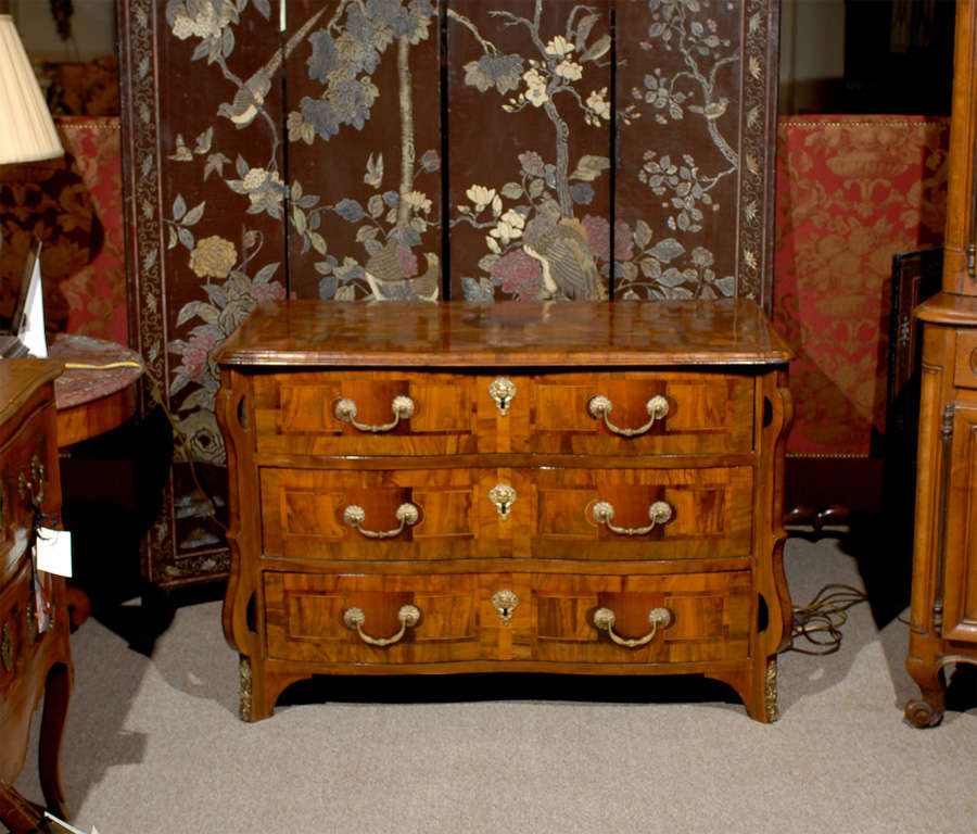 A fine Louis XIV style walnut inlaid commode with serpentine front and ormalu mounts. 