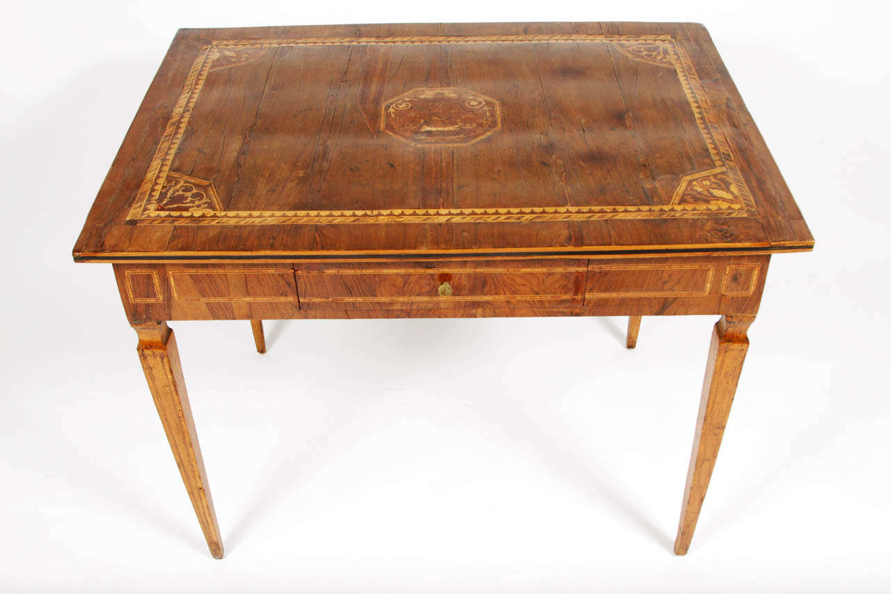 Beautiful walnut table with marquetry inlay, most likely tulipwood or fruitwood.  Apron drawer with pull.  Italian c.1790.