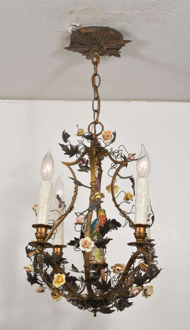 Gilt Bronze Capodimonte chandelier with porcelain parrot and small individual porcelain roses in varied colors.  Newly wired and includes a coordinating ceiling canopy. Uses 4 chandelier bulbs.
