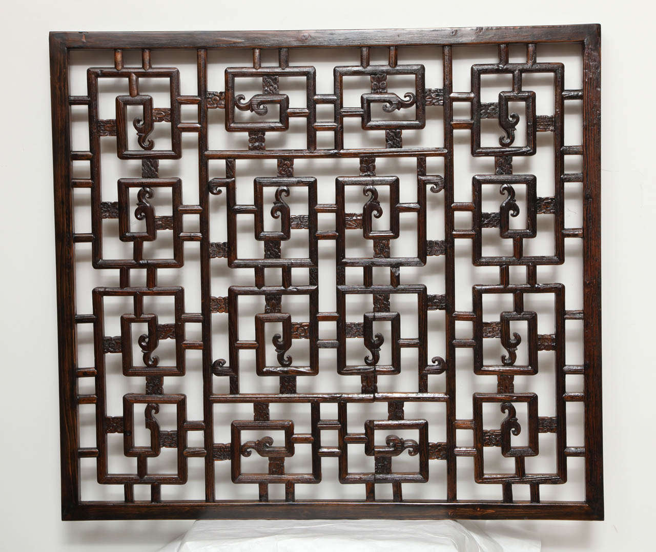 A carved wood lattice screen panel from China.  Traditional lattice pattern with carved accents.  A unique wall hanging, suitable for mirror backing.