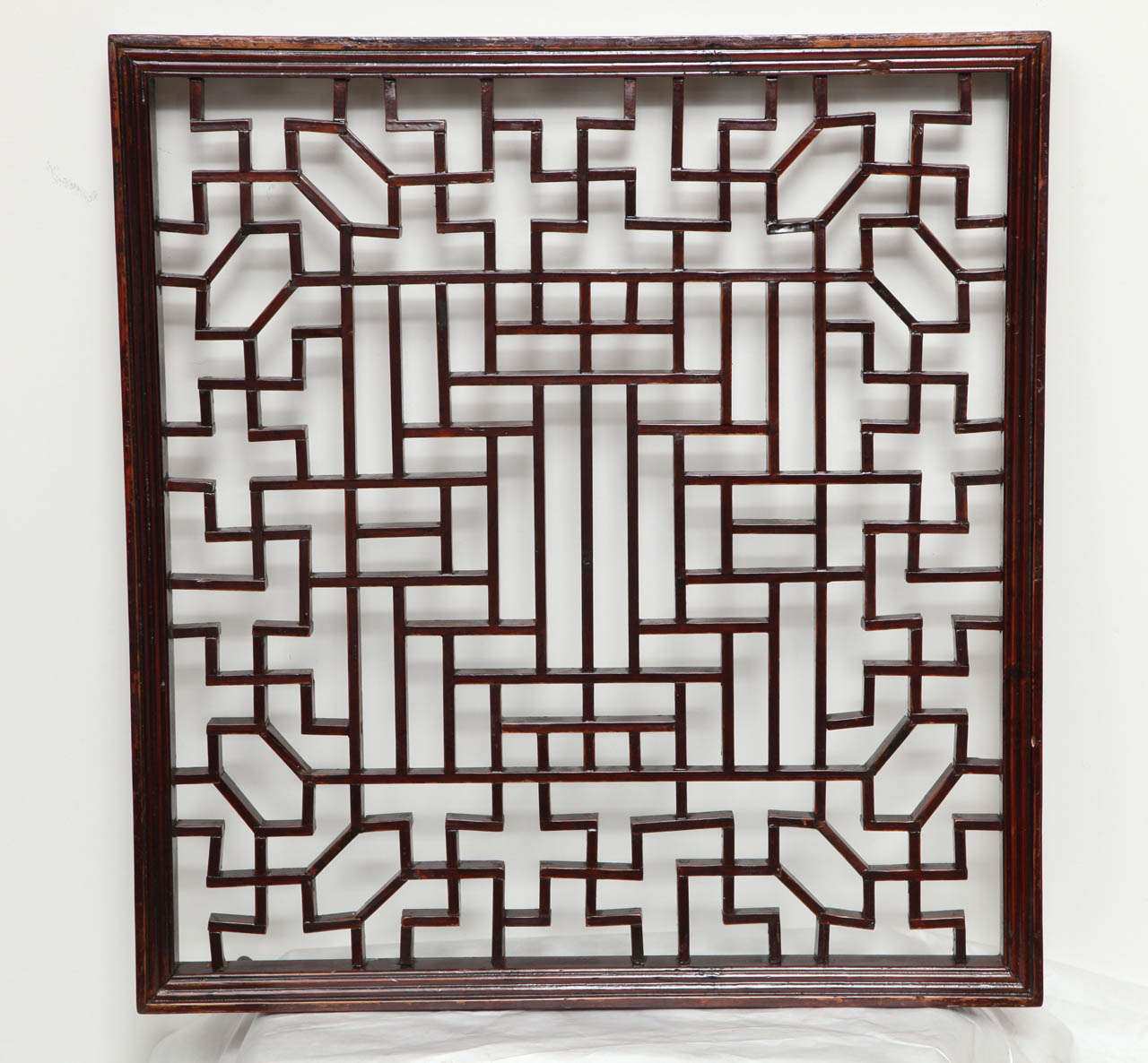 A small wood lattice screen panel in a traditional Chinese pattern.  Can be mirror backed