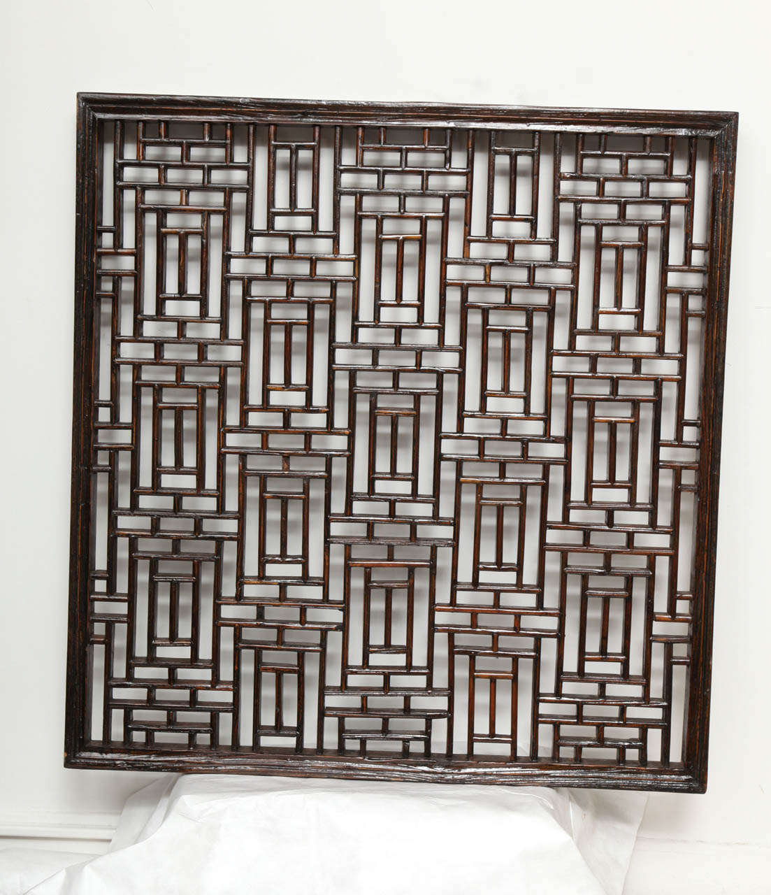 A wood lattice screen or panel in a traditional Chinese pattern.  Can be mirror backed.