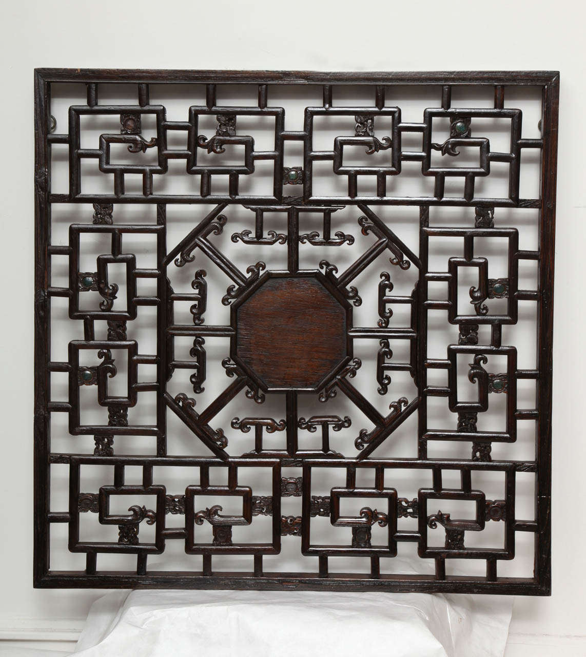 An elwood lattice screen panel with a Classic Chinese pattern and octagonal center and carved accents. Use as wall decor or divider. Center panel can be removed. Suitable for mirror backing.