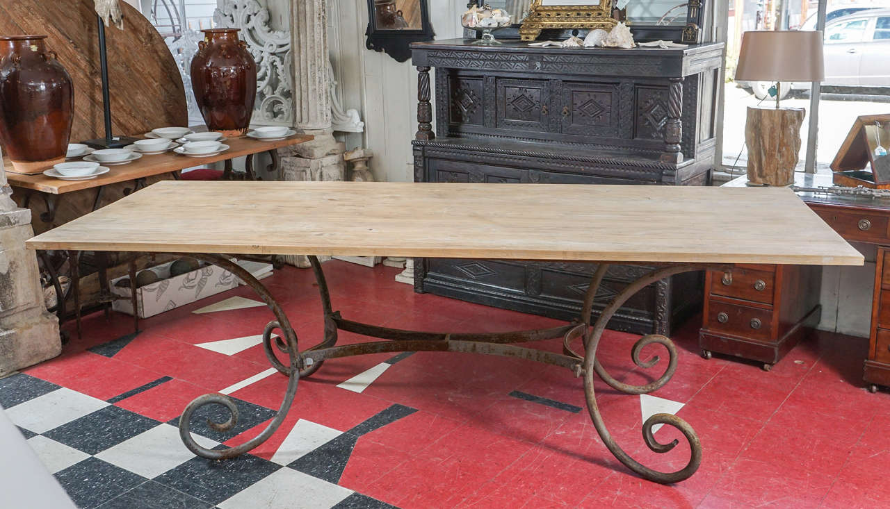 Country elegance is the key here. The teakwood top dining table has a rustic but smooth surface and the boards are secured underneath by cross boards. Leave the iron base in its rusty condition or paint it shiny black. Top and base can be sold