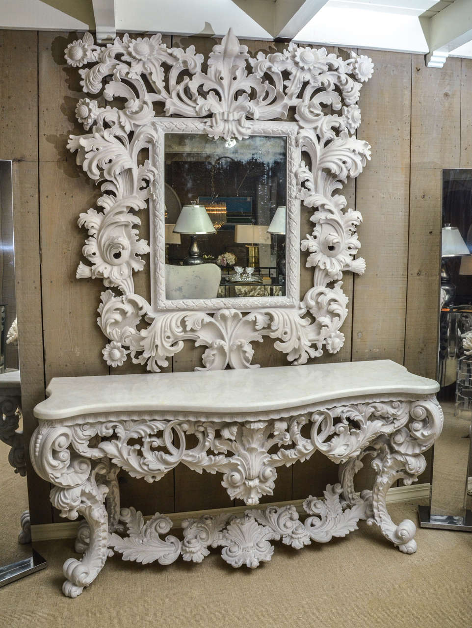 Magnificent white carved console with white marble top and matching mirror. The mirror is 55 W x 64 H.