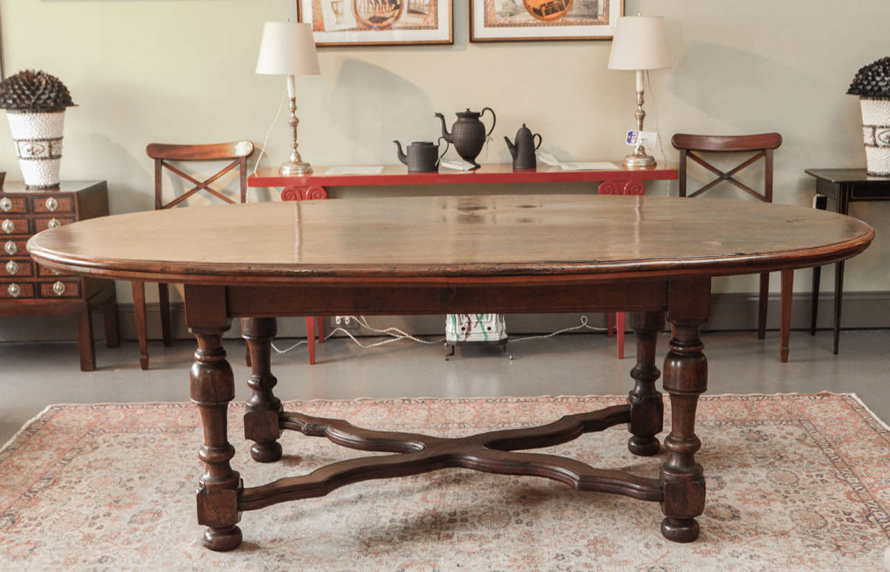 A Large Oval Walnut Italian Table, early 19th c. Perfect for a dining or center table.