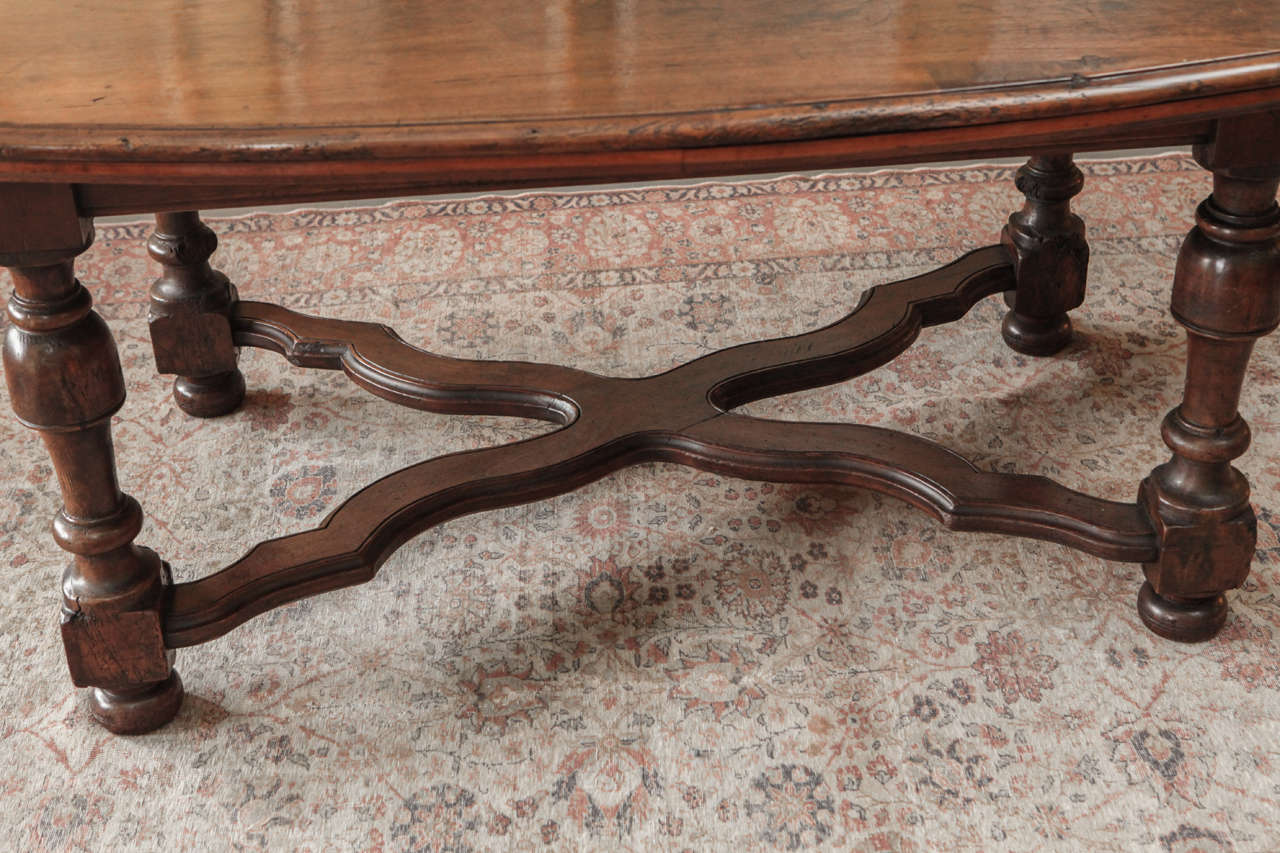 19th Century A Large Oval Walnut Italian Table, early 19th c.