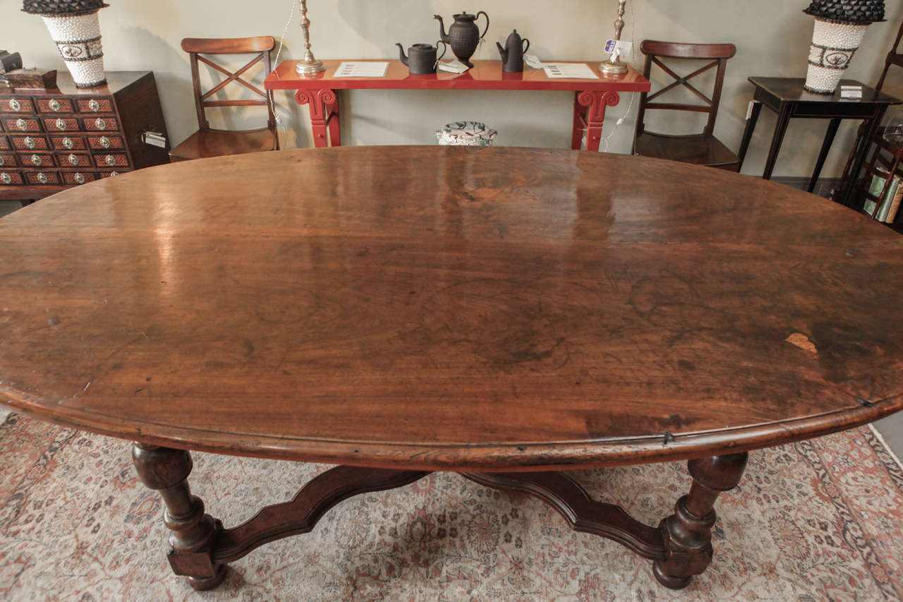 A Large Oval Walnut Italian Table, early 19th c. 2