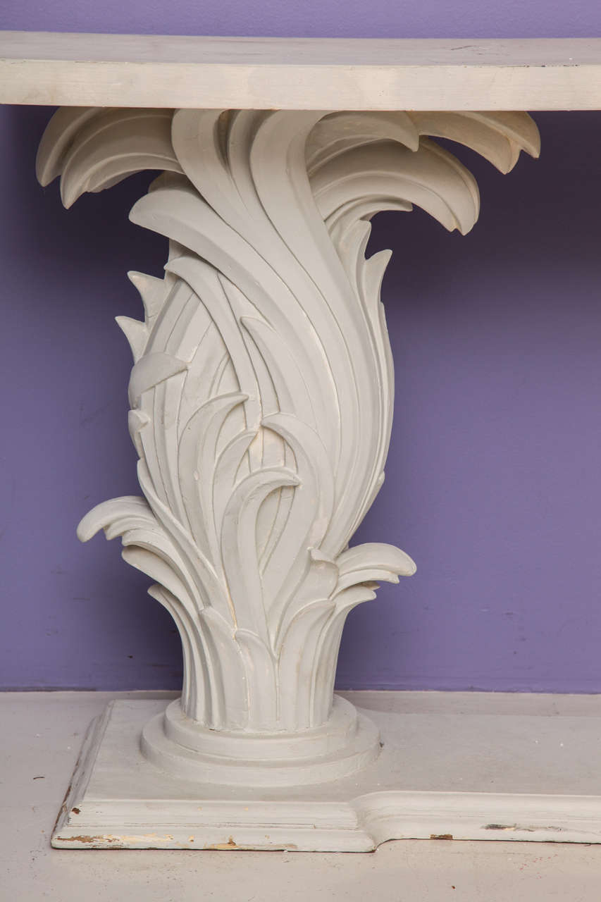 Console table with a painted wood base and two plastered wood columns of curling palm leaves supporting a rectangular top.
French, c. 1965