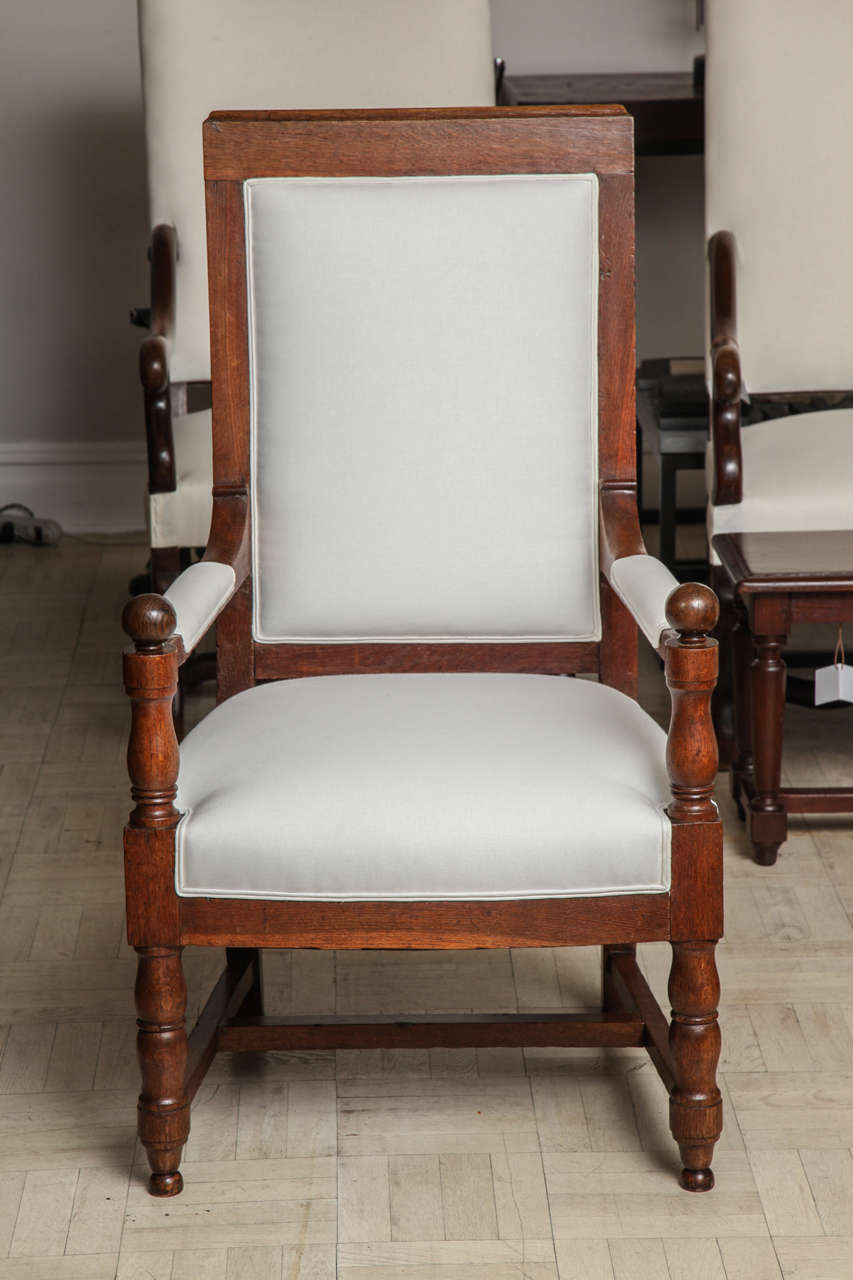 19th century oak armchair, Louis XIV style, upholstered back and seat, padded armrests ending in ball finials, turned straight legs.