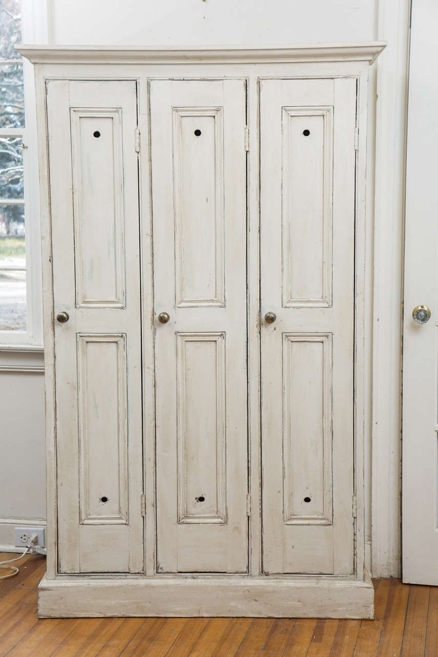 We are fortunate to get golf lockers from several golf clubs in the Yorkshire area of the UK. This one is painted a soft cream color with undertones of a grey or green. The inside has a top shelf in each locker, as well as two old hooks in each