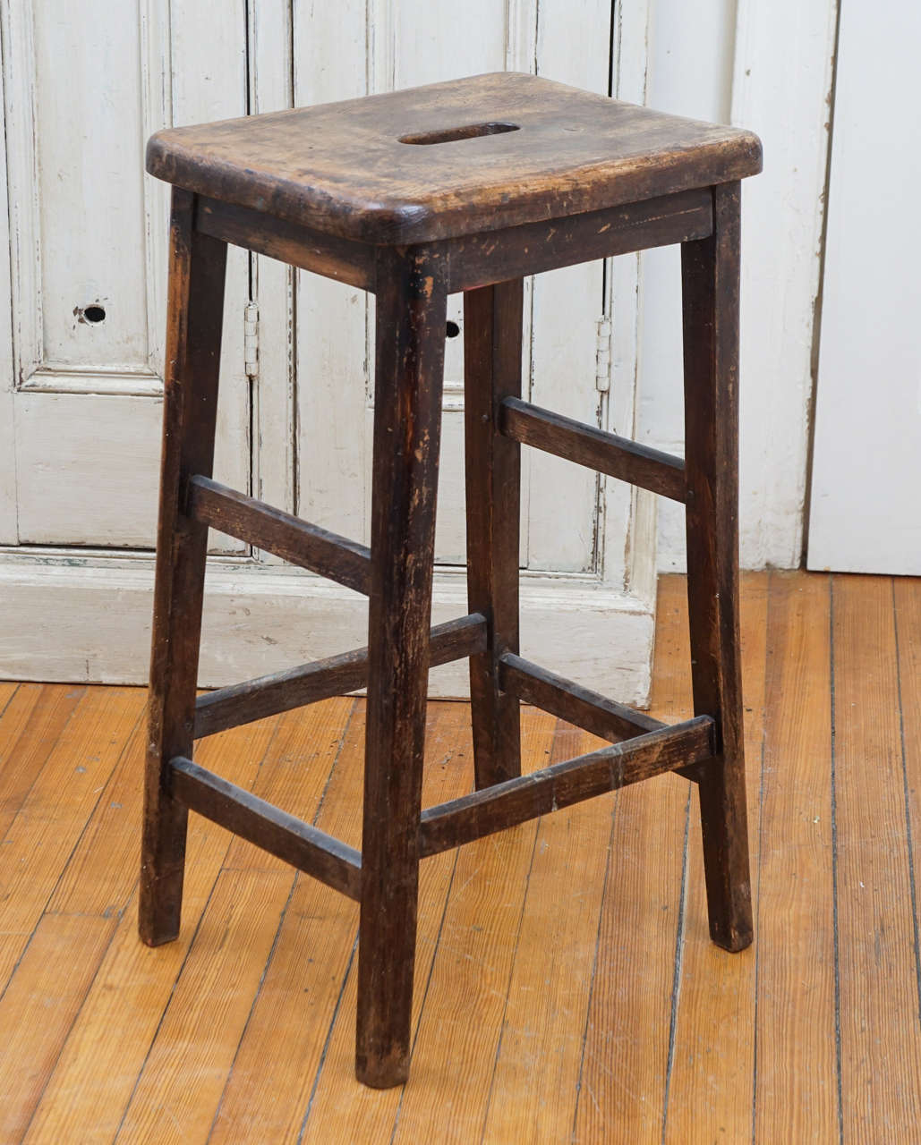This is part of a collection of pub stools at painted porch. Each piece is unique and different. All of them can be used at a center island in a kitchen. Each could be cut by our restorer should you desire a shorter height. This particular stool has