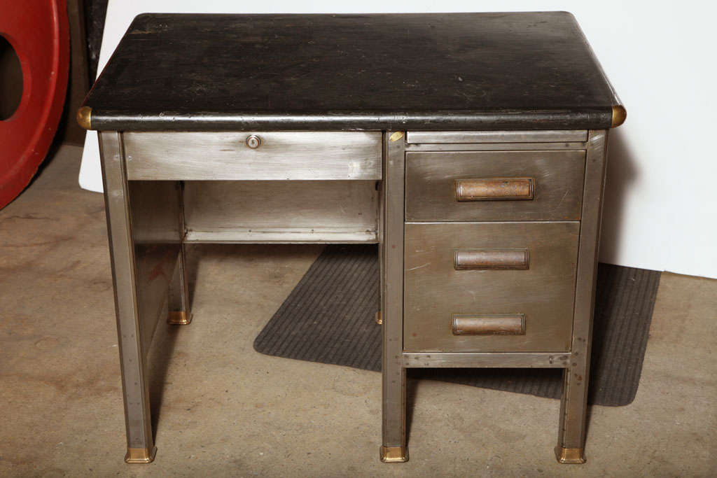 Industrial Metal Desk with faux Leather composite Desk top.  This 3 drawer desk includes 3 Bakelite handles.  Pencil drawer locks 2 Side drawers.  Complete with pull out File Cabinet drawer and Typewriter shelf - perfect temporary surface, possibly