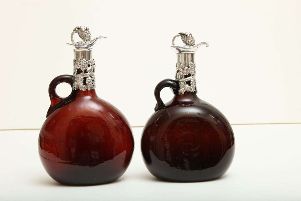 Beautiful pair of Mid-Victorian hand-blown brown glass decanters by Thomas Smily. Impressively detailed with a grapevine motif, these matching decanters are of exceptional quality. The stoppers are cleverly designed as a vine holding a bunch of