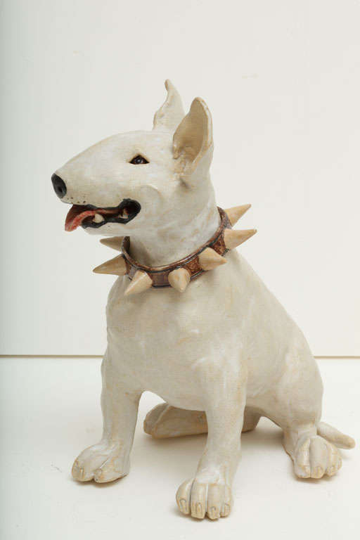A superbly sculpted piece capturing the Bull Terrier's personality. He wears a large studded collar around his neck. His collar and paws are hallmarked with an 