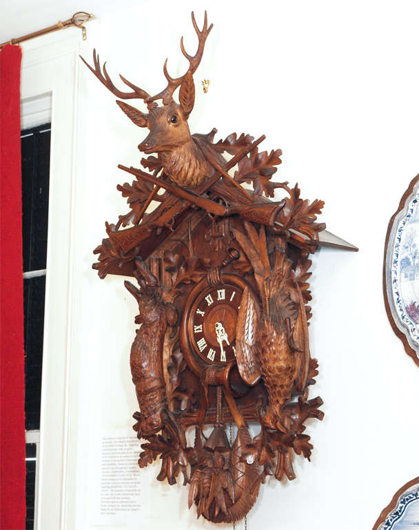 Exceptional Black Forest Cuckoo Clock of Monumental proportions. It has ivory numerals and hands with exceptionally carved case.