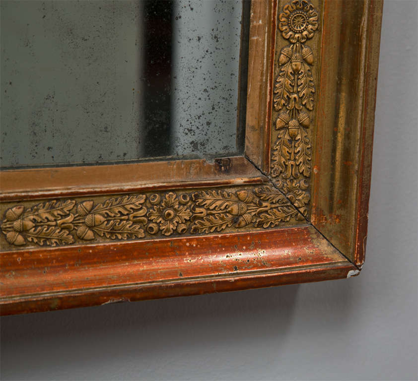 French gilded mirror, Empire period, c. 1810, with original gilding and  2 mirror plates, carved with oak leaves and acorn clusters.