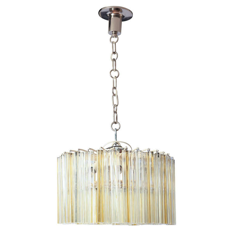 Chandelier or ceiling light designed and executed by Venini, Murano (Italy). 'Trilobo' model made with solid glass trilobed rods.
Impressed signature -Venini Murano Made in Italy- on the frame.