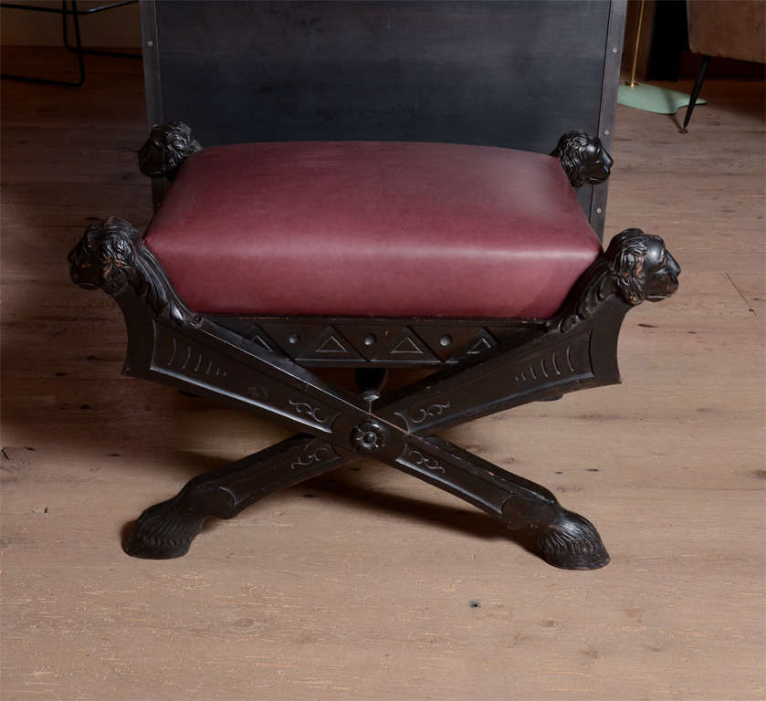 Fabulous pair of 1940's spanish ebonized stools in Regency taste re-upholstered in oxblood leather.