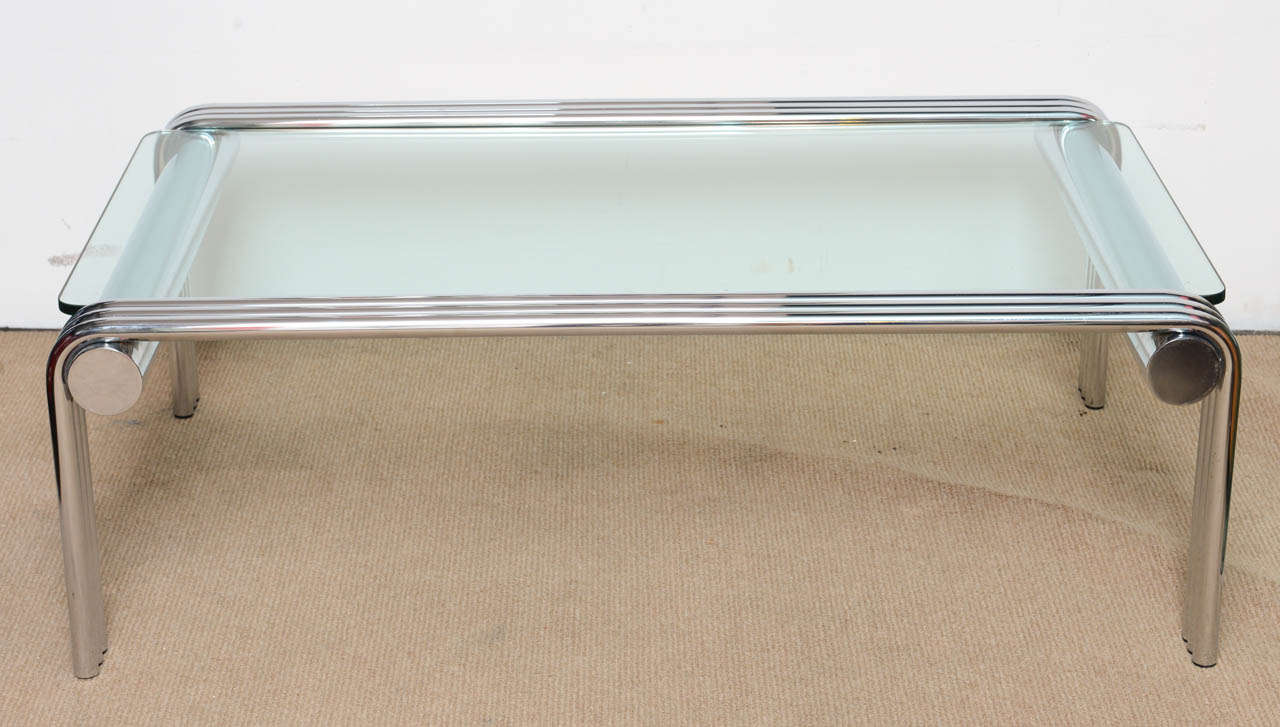 This 1970's tubular chrome and Glass coffee table is in beautiful Vintage condition. A perfect addition to any design from Modernist to Metropolitan Glam home. The  glass top sits upon the chromed steel tubular and has been replaced and made