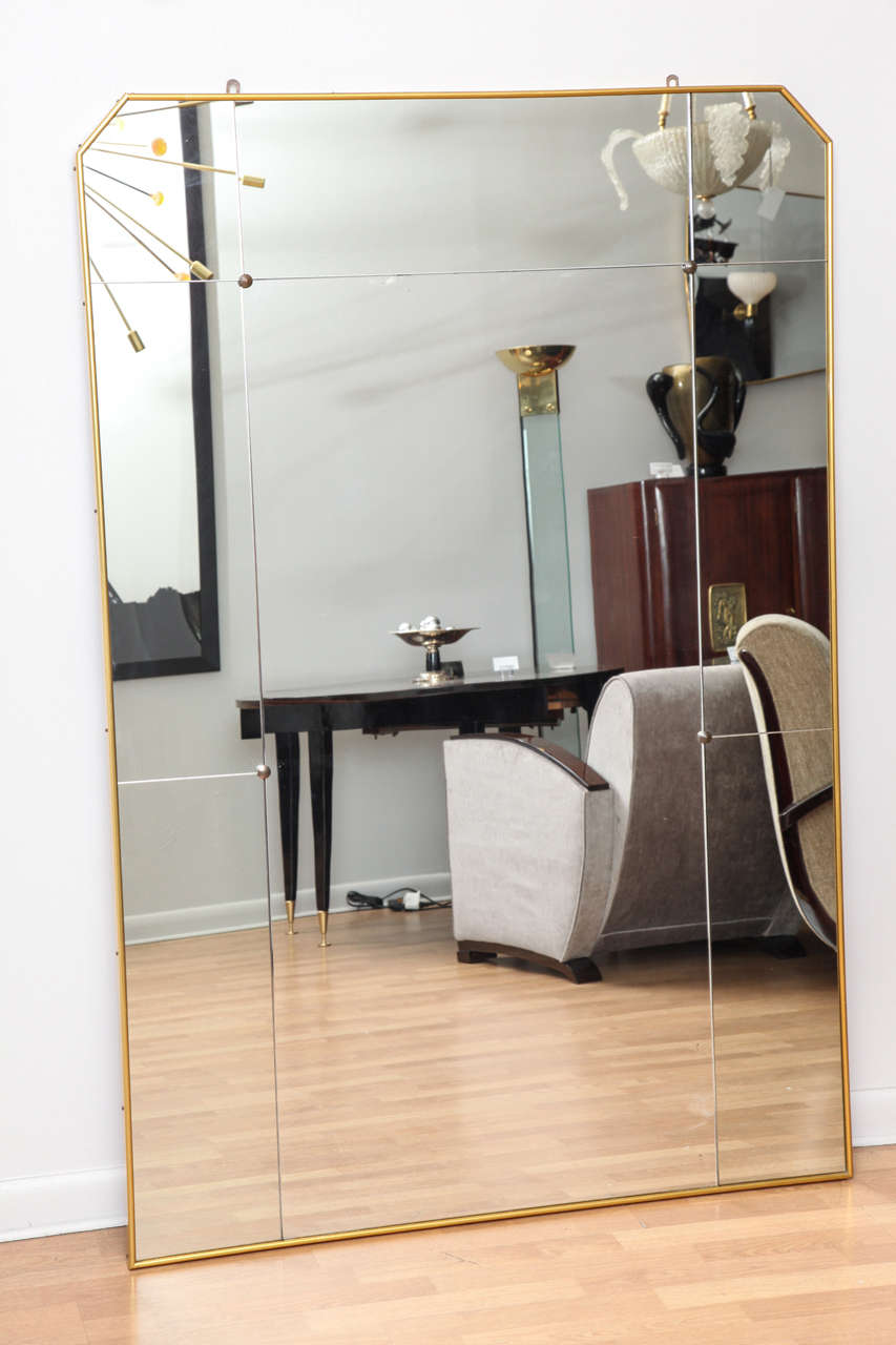 Grand Art Deco wall mirror with brass frame.