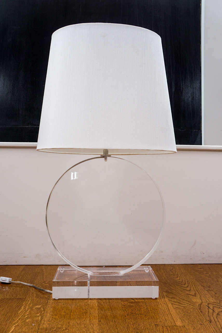 solid Lucite table lamp with dual, single socket, brass clusters.
crisp, oval linen shade.
great look!!
