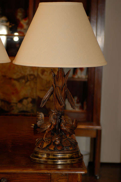 Pair of Black Forest carved chickens made into lamps on custom bases. Shades included.