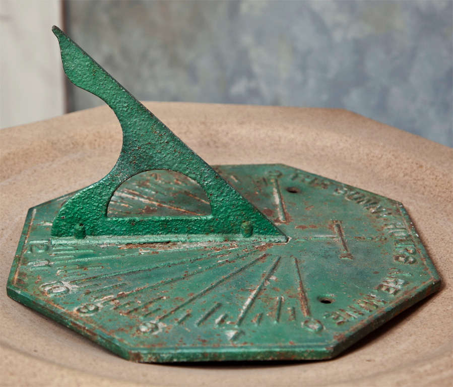 It is exceptionally rare when we come across an American sundial plate, as they were uncommon American garden ornaments. This large octagonal cast iron plate has its original gnomon (pointer) and is cast with the motto 