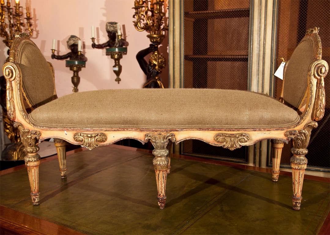 Charming French polychromed and parcel-gilt banquette, circa 1940s in the style of Regence, upholstered in burlap, rectangular seat with raised sides, beautiful decorated frame and apron, raised on fluted legs.