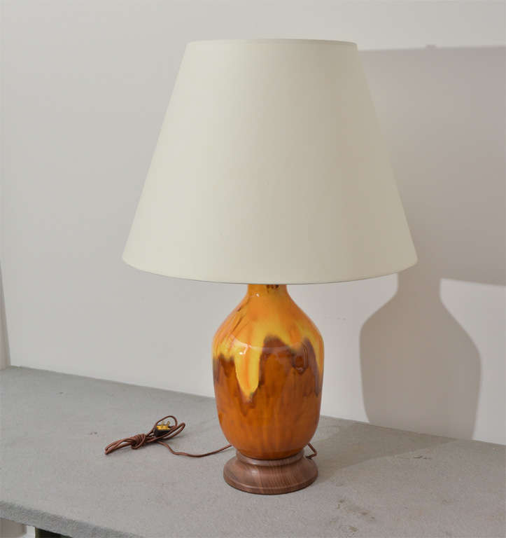 Brown and yellow glazed ceramic vase that has been converted into a table lamp with wooden base, handsome brass fittings, and brown silk cord. 

Shade is not included.
  