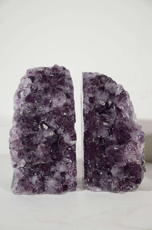 Beautiful set of large natural <br />
and polished geode crystal <br />
bookends. Known for their <br />
healing qualities, the Amethyst<br />
crystals have gradient hues of <br />
deep purples and violet. <br />
Make wonderful decorative<br