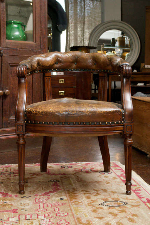 Tufted leather and mahogany barrel-back library chair, English, circa 1860.